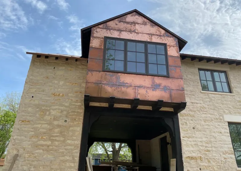 Copper metal panel facade on a stone building for Skylight Installation in Troy