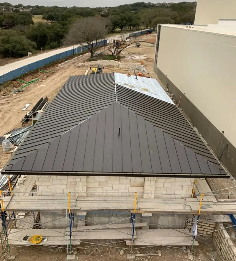 Metal roof new construction with scaffolding in Troy